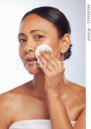 Skincare, senior or woman portrait with cotton pad for dermatology, wellness or healthy facial skin. Studio background, glow or face of mature person with swab for beauty, cleansing or dirt removal 135426344