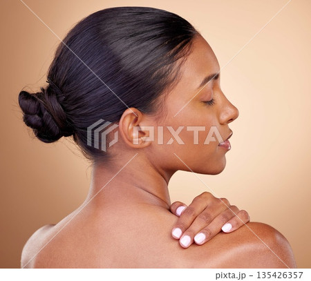 Beauty, face and woman touch back with natural skincare shine, cosmetics treatment and morning self care routine. Spa salon, dermatology or Indian person with anti aging skin glow on brown background Beauty, face and woman touch back with natural skincare shine, cosmetics treatment and morning self care routine. Spa salon, dermatology or Indian person with anti aging skin glow on brown background 135426357