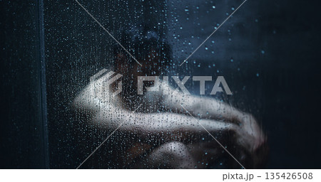 Man, dark shower and sad by glass in home, stress and mental health with ptsd for bad memory. Person with depression, burnout and anxiety with water drops, window and frustrated in bathroom at house Man, dark shower and sad by glass in home, stress and mental health with ptsd for bad memory. Person with depression, burnout and anxiety with water drops, window and frustrated in bathroom at house 135426508