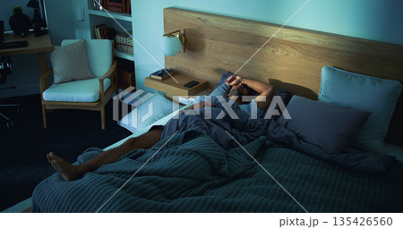 Night, stress and man with depression, mental health and sleepless from sad memories in bedroom. Late, above and anxious person with grief, fatigue and insomnia from difficulty in apartment. 135426560