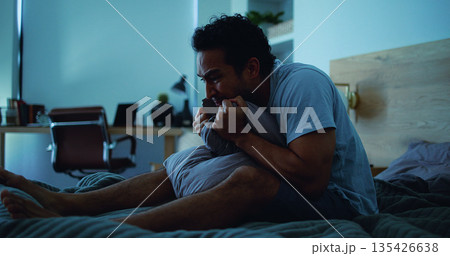 Night, pillow and stressed man with anxiety, mental health and sleepless from sad memories in bed. Late, contemplation and anxious person with depression, grief and insomnia from frustration in home. 135426638