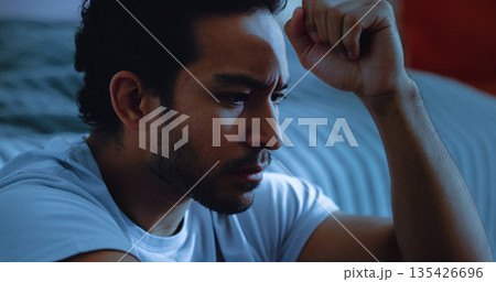 Night, worry and man thinking with anxiety, mental health or insomnia from sad memories in bedroom. Late, contemplation or anxious person with depression, grief or sleepless from stress in apartment. Night, worry and man thinking with anxiety, mental health or insomnia from sad memories in bedroom. Late, contemplation or anxious person with depression, grief or sleepless from stress in apartment. 135426696