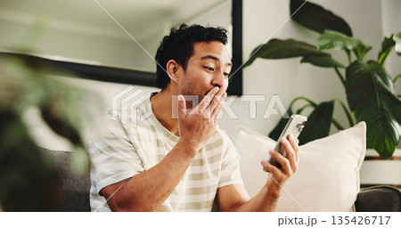 Man, blow kiss and video call on sofa, phone and happy for conversation in living room at home. Person, tech and smile with mobile app, contact or virtual web chat on couch with greeting at apartment Man, blow kiss and video call on sofa, phone and happy for conversation in living room at home. Person, tech and smile with mobile app, contact or virtual web chat on couch with greeting at apartment 135426717