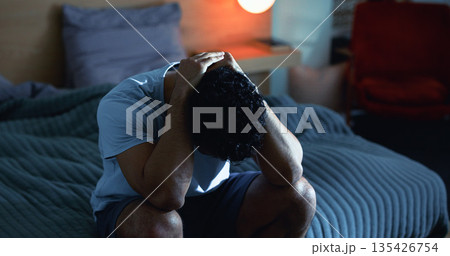 Insomnia, night and man in bedroom with stress for burnout, exhausted and fatigue for mental health. Tired, dark and person with upset, sad and anxiety for sleepless, bad dream and frustrated in home Insomnia, night and man in bedroom with stress for burnout, exhausted and fatigue for mental health. Tired, dark and person with upset, sad and anxiety for sleepless, bad dream and frustrated in home 135426754