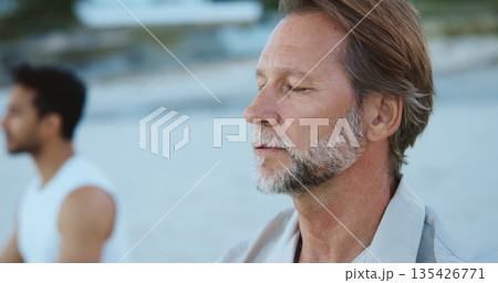 Men, breathing and meditation for mindfulness, beach and routine for peace, break and stress relief. Outdoor, fresh air and people with spiritual awareness in nature, calm and inhale for wellness 135426771