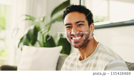 Man, smile and relax on sofa in portrait, home and pride with confidence, break or rest in lounge. Person, happy and chill on couch, weekend and comfort in living room at apartment in Malaysia 135426989
