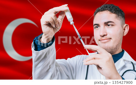 Doctor holding syringe on Turkey flag background. Medical professional holding syringe with Turkish flag in the background 135427900
