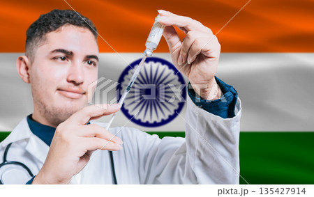 Doctor holding syringe on India flag background. Medical professional holding syringe with Indian flag in the background 135427914