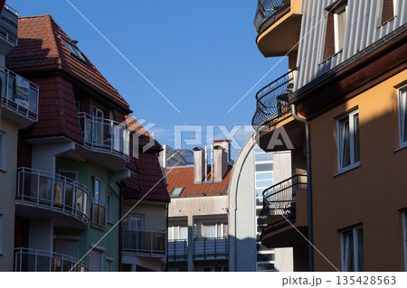 Urban scene with multicolored buildings and clear blue sky showing modern 135428563