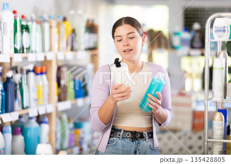 Young woman choosing shampoo and shower gel in department store Young woman choosing shampoo and shower gel in department store 135428805
