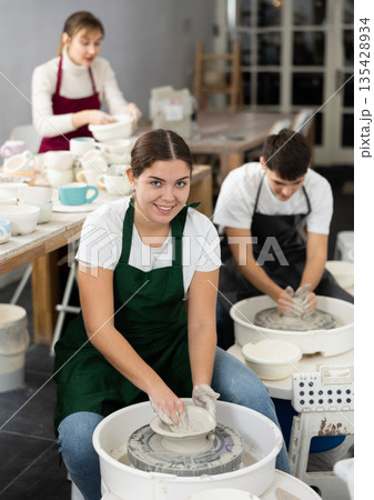 Woman working with pottery wheel Woman working with pottery wheel 135428934