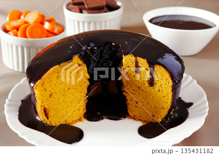 Brazilian Carrot Cake with Chocolate Frosting, cut in half, on a pastry table Brazilian Carrot Cake with Chocolate Frosting, cut in half, on a pastry table 135431182