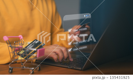 Online shopping and order management concept showing person using laptop with credit card and virtual order list, symbolizing e-commerce transaction, digital retail system, and secure online payment. Online shopping and order management concept showing person using laptop with credit card and virtual order list, symbolizing e-commerce transaction, digital retail system, and secure online payment. 135431925