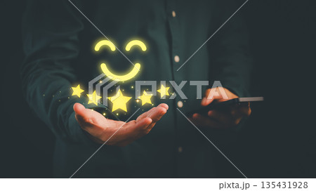 Customer satisfaction concept showing five-star rating and smiling face icon on hand, symbolizing excellent service, positive feedback, customer service, and successful online business reputation. Customer satisfaction concept showing five-star rating and smiling face icon on hand, symbolizing excellent service, positive feedback, customer service, and successful online business reputation. 135431928