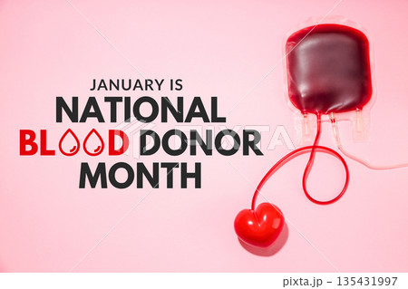 A blood bag with red liquid and a heart shape attached 135431997