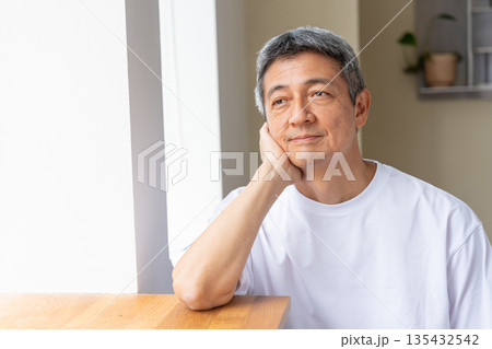 頬杖をつく笑顔の男性 135432542