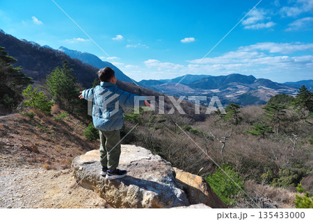 由布岳から麓を見下ろす少年 135433000