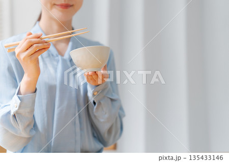 ご飯を食べる女性の手元 135433146
