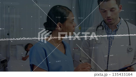 Standing nurse in blue scrubs holding pen and listening in hospital ward, with waveform overlay 135433164