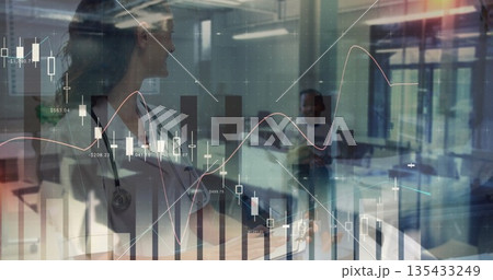 Standing doctor in white coat, stethoscope in clinic with desk monitors, data overlay, copy space 135433249