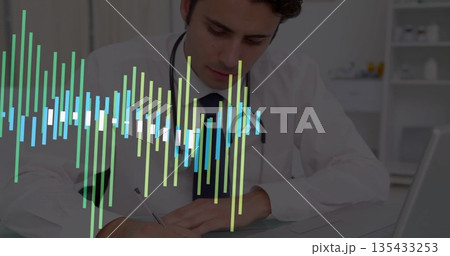 Physician wearing lab coat writing notes on pad at medical office desk, with stethoscope and laptop Physician wearing lab coat writing notes on pad at medical office desk, with stethoscope and laptop 135433253