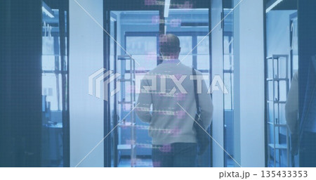 Man in sweater with black bag passing security scanners at office entry, with holographic overlays Man in sweater with black bag passing security scanners at office entry, with holographic overlays 135433353
