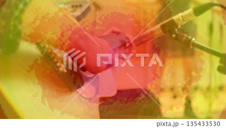 Musician strumming acoustic guitar in shirt on stage, with guitar strap and microphone stand cable Musician strumming acoustic guitar in shirt on stage, with guitar strap and microphone stand cable 135433530