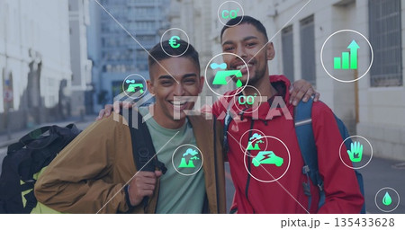 Two men wearing layered jackets with backpacks standing on city walkway, with sustainability icons 135433628