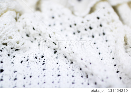 Cozy textured crochet, Closeup of warm crochet throw with detailed fiberwork and gentle folds 135434250