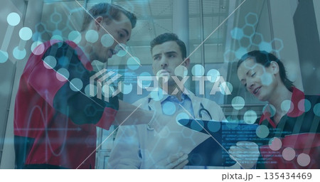 Discussing lead doctor holding clipboard and stethoscope in glass corridor, with molecular overlay Discussing lead doctor holding clipboard and stethoscope in glass corridor, with molecular overlay 135434469
