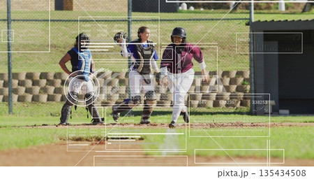 Softball player in jersey and helmet sliding into home plate on infield, with HUD, copy space 135434508
