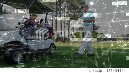 Driving couple in golf attire in cart on fairway, with man checking smartphone by golf bag Driving couple in golf attire in cart on fairway, with man checking smartphone by golf bag 135434544