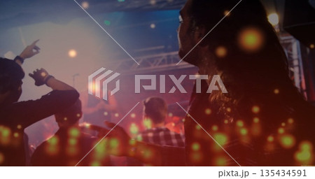 Long-haired man in plaid standing amid crowd at music venue, facing stage with fog, copy space Long-haired man in plaid standing amid crowd at music venue, facing stage with fog, copy space 135434591