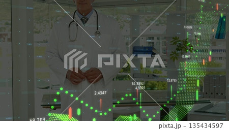 Reviewing senior physician analyzing floating digital graphs in medical office, with stethoscope 135434597