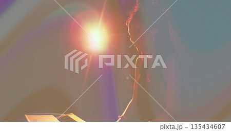 Performing woman musician playing electronic keyboard on dark stage, warm lens flare, copy space 135434607
