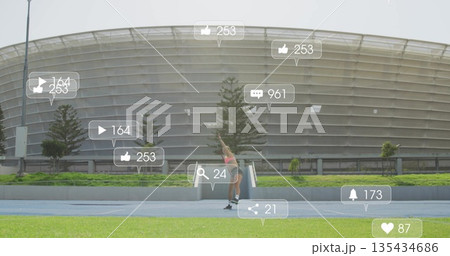 Athlete stretching in pink top, shorts on blue track at stadium, with floating social media icons Athlete stretching in pink top, shorts on blue track at stadium, with floating social media icons 135434686