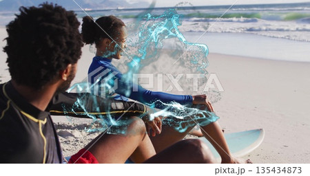 Watching friends in rash guards sitting on sand at ocean edge, with surfboard and water effect Watching friends in rash guards sitting on sand at ocean edge, with surfboard and water effect 135434873