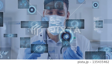 Clinician wearing mask and gloves preparing injection in lab, with syringe vaccine vial data panels Clinician wearing mask and gloves preparing injection in lab, with syringe vaccine vial data panels 135435462