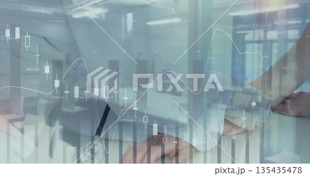 Doctor with stethoscope typing and jotting at desk with laptop and clipboard financial charts 135435478