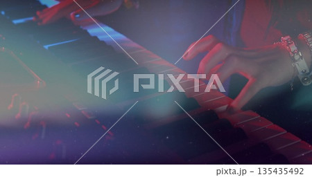 Playing musician's hands pressing keyboard with watch on stage, colored lights and haze Playing musician's hands pressing keyboard with watch on stage, colored lights and haze 135435492