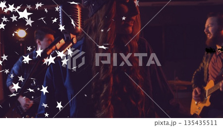 Singing female vocalist wearing knit cap, dark coat on stage, with vintage mic, star graphics 135435511