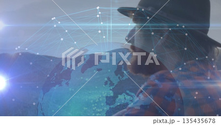 Projecting silhouette man wearing fedora plaid shirt on network globe and lens flares, copy space 135435678