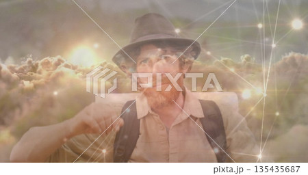 Man in fedora, button-up shirt with backpack gazing at sunset clouds, with network nodes and lines Man in fedora, button-up shirt with backpack gazing at sunset clouds, with network nodes and lines 135435687