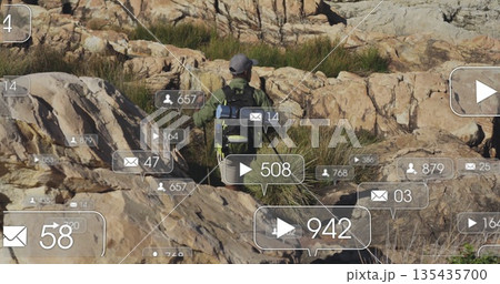 Hiking male hiker navigating hill, wearing jacket and cap with backpack and social media icons 135435700