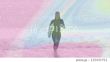 Emerging surfer in wetsuit striding through waves at beach, carrying turquoise surfboard, pastels 135435751