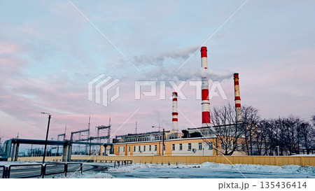 urban thermal power plant in the evening, a thermal power plant with cooling towers producing energy during Winter and cold months. Pink, purple clouds 135436414