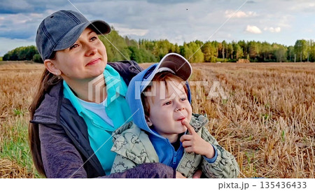 Portrait of a young woman and child. Mom and her boy kid spending time together on nature. Mom and son spend time together in nature. Quality time with child. Portrait of a young woman and child. Mom and her boy kid spending time together on nature. Mom and son spend time together in nature. Quality time with child. 135436433