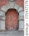 Bricked up stone arch in historic brick wall 135437176