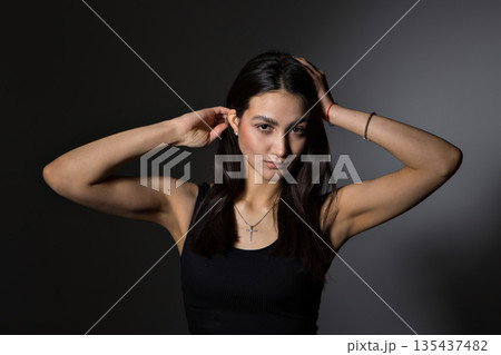 A woman with black hair wakes up in the morning in a white blanket and catches the rays of the sun. The portrait is creative, with brown eyes. High quality photo A woman with black hair wakes up in the morning in a white blanket and catches the rays of the sun. The portrait is creative, with brown eyes. High quality photo 135437482