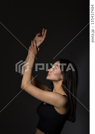 A woman with black hair wakes up in the morning in a white blanket and catches the rays of the sun. The portrait is creative, with brown eyes. High quality photo A woman with black hair wakes up in the morning in a white blanket and catches the rays of the sun. The portrait is creative, with brown eyes. High quality photo 135437484